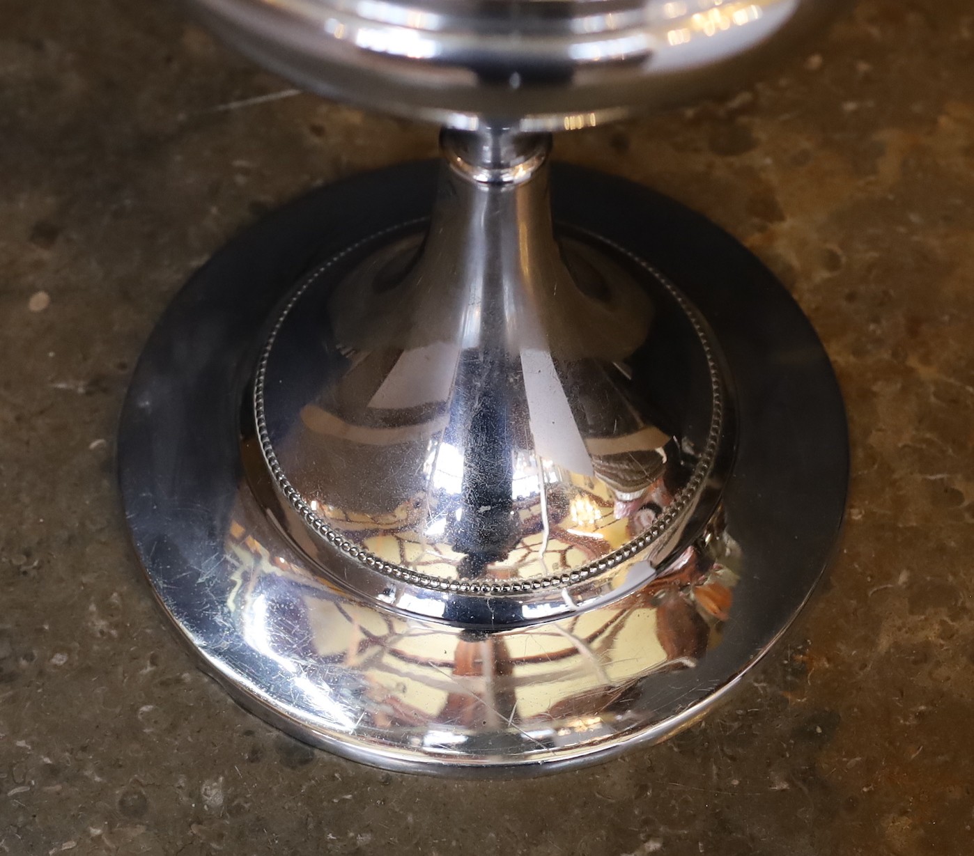 A 1930s nickel plated oil lamp with plain glass flue, height overall 68cm